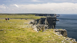 Images Dated 25th May 2008: Inishmore Island. Aran Islands. Ireland. Limestone Sea Cliffs. Atlantic Coast. Hikers