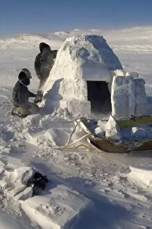 inupiat guides Bruce Inglangasak and Jack Kayotuk finish building an igloo snow blind