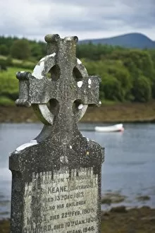 Ireland, Clare, Ross Abbey. Celtic Cross tombstone with Croagh Patrick mountain in the background