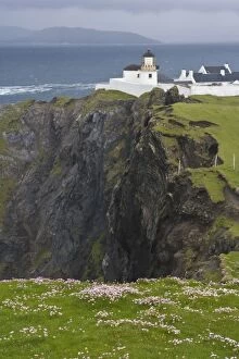 Ireland, County Mayo, Achill Island Lighthouse and dramatic cliffs above the Atlantic Ocean