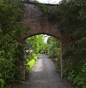 Dromoland Castle Prints: Ireland, the Dromoland Castle very green walled garden path through a brick archway