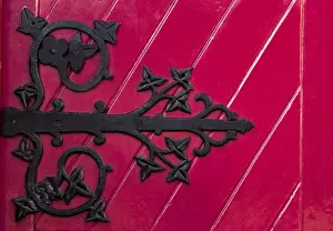 Striking Prints: Ireland, Ennis. A decorative black hinge on a bright red door of the new Franciscan