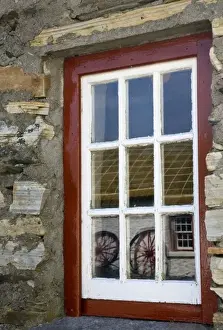 Cottage Prints: Ireland, Gleann Cholm Chille. Reflection of wagon wheels in a red- trimmed window