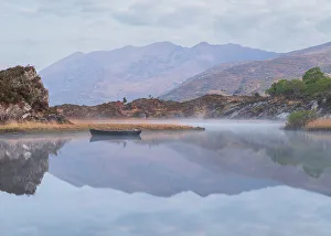 Images Dated 26th November 2022: Ireland, Lough Leane. Boat and reflections on lake