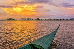 Outrigger Prints: Irrawaddy River, Laos. Wide angle landscape view of Irrawaddy River at sunset from an outrigger