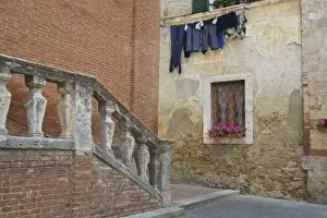 Italy, Asciano, Window Boxes with Fresh Spring Flowers and Laundry Hanging on The Line
