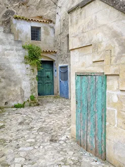 Courtyard Prints: Italy, Basilicata, Matera. Doors in a courtyard in the old town of Matera