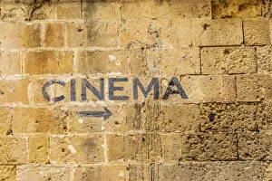 Images Dated 22nd August 2019: Italy, Basilicata, Province of Matera, Matera. Sign on a wall pointing to a cinema