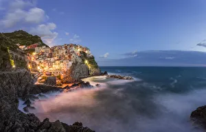 Lighting Prints: Italy, Cinque Terre, Manarola. Hilltop town and stormy ocean at sunset. Credit as