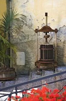 Italy, Cinque Terre, Riomaggiore. Old olive press decorates stairway