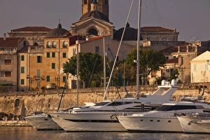 Images Dated 11th May 2009: Italy, Sardinia, Alghero. City walls from the yacht marina, sunrise