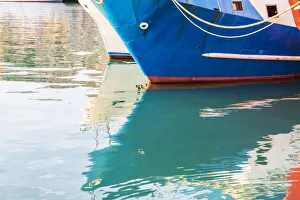 Images Dated 4th February 2020: Italy, Sicily, Agrigento Province, Sciacca. Reflection of a fishing boat in the harbor of