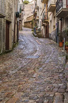 Winding Road Prints: Italy, Sicily, Palermo Province, Geraci Siculo. Winding narrow cobblestone street in