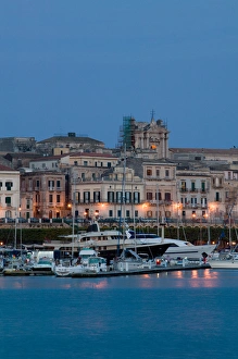 Images Dated 18th May 2005: ITALY-Sicily-SIRACUSA (Syracuse): Evening View of Ortygia Island from Commercial Port