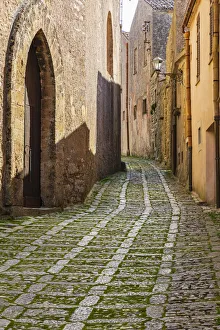 Prints of Italy, Sicily, Trapani Province, Erice. A narrow cobblestone street in the ancient hill town of Erice Images Dated 2020 February: Italy, Sicily, Trapani Province, Erice. A narrow cobblestone street in the ancient hill