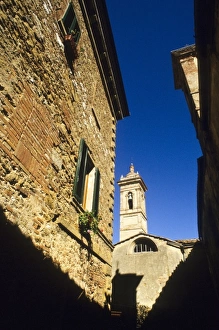 Church Tower Prints: Italy: Tuscany, Castelmuzio, brick homes, windows with green shutters, with church