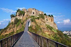 Images Dated 11th October 2022: Italy, Tuscany. Evening view of Civita di Bagnoregio and the long bridge leading to town