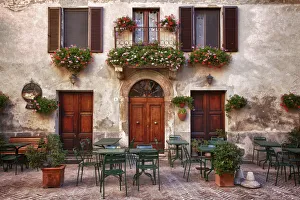 Europe Prints: Italy, Tuscany, Pienza. Tables and chairs set up outside for outdoor dining in the town of Pienza