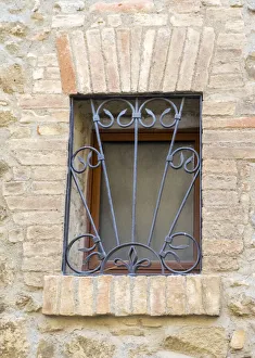 Images Dated 1st July 2022: Italy, Tuscany, Province of Siena, Montalcino. Iron-barred window