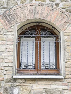 Images Dated 1st July 2022: Italy, Tuscany, Province of Siena, Montalcino. Iron-barred window