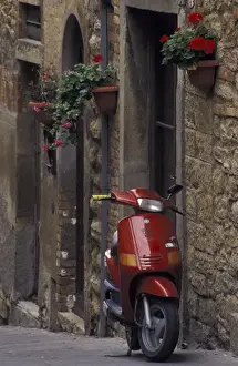 Motorbike Prints: Italy, Tuscany, Volterra Geraniums and motorcycle on narrow street