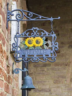 Images Dated 3rd January 2021: Italy, Tuscany. A wrought iron welcome sign in the village of Chiusure in the province of