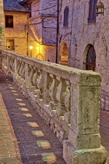 Umbria Prints: Italy, Umbria, Assisi. Short stone wall with columns near the Convento Chiesa Nuova