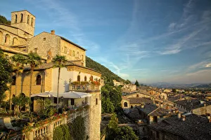 Umbria Prints: Italy, Umbria. Evening light on flower covered buildings overlooking the medieval town of Gubbio