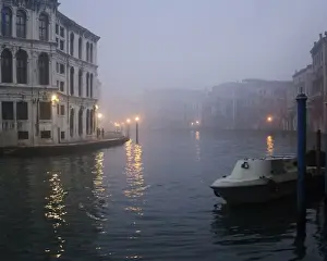 Italy, Venice. Boat moored on Grand Canal in early morning fog