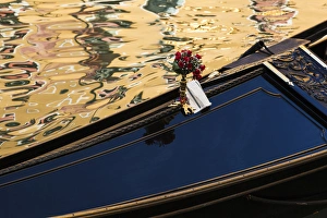 Images Dated 19th May 2010: Italy, Venice. A gondola detail and colorful water reflections