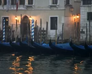 Italy, Venice. Gondolas moored in front of hotel in early morning light