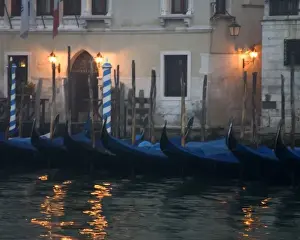 Italy, Venice. Gondolas moored in front of hotel in early morning light