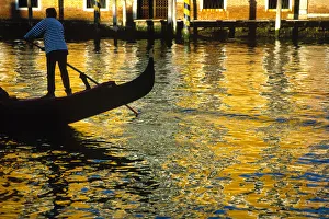 Images Dated 14th September 2018: Italy, Venice. Gondolier steering gondola at sunset