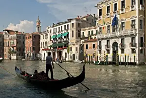 Riverfront Prints: Italy, Venice. Tourists ride in a gondola on the Grand Canal of Venice