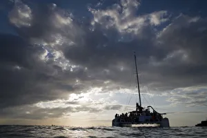 Images Dated 24th April 2007: Jamaica, Negril, Low Angle view of tourist catamaran boat near Pirates Cave at sunset