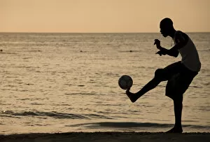 Images Dated 22nd April 2007: Jamaica, Negril, Silhouette of young men playing soccer along Caribbean Sea