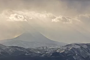 Japan Collection: Japan, Hokkaido, Tsurui. God rays shine over mountain