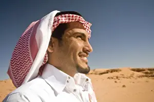 Wadi Rum Prints: Jordan, Wadi Rum. A lone Bedouin tribesman surveys the sands and rocky terrain of his homeland