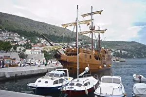 16th Century Prints: The Karaka 16 century galleon replica boat in the old harbour. Other boats moored