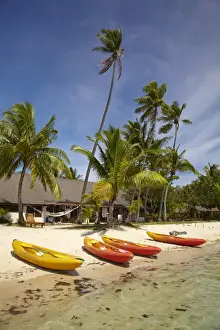 Images Dated 23rd October 2011: Kayak on the beach, and waterfront bure, Plantation Island Resort, Malolo Lailai Island