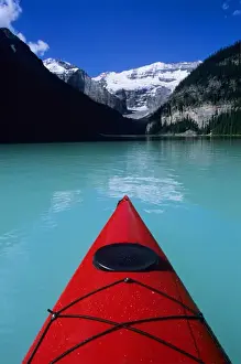 Sea Kayak Prints: Kayak on Lake Louise below Mount Victoria in the Canadian Rockies; Banff National Park; Alberta