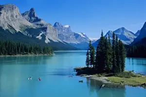 Sea Kayak Prints: Kayaking on Maligne Lake at Spirit Island below the Elizabeth Range in Jasper National Park