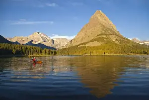Sea Kayak Prints: Kayaking in Swiftcurrent Lake at sunrise in the Many Glacier Valley of Glacier National Park