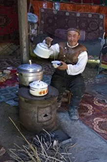 Kazakh man drinking tea in his yurt. (MR)