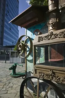 KOSOVO, Prishtina. Display of Old Circus Wagon and modern Kosovo Government Building