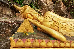 Reclining Buddha Prints: Laos, Luang Prabang. Reclining Buddha statue on Mount Phousi