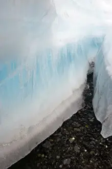 Melt Prints: A large crevice in the arctic aufeis revealing laminations of ice above the dark