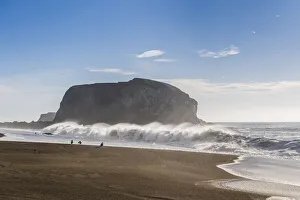 Crashing Prints: Large haystack rock with crashing waves and birds on the beach in California