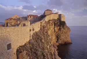 Late Afternoon light creates a warm glow on the rocky coastline and ancient historic