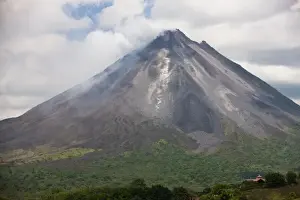 Erupting Prints: Lava rocks are thrown from the erupting Arenal volcano to the mountainside and forest